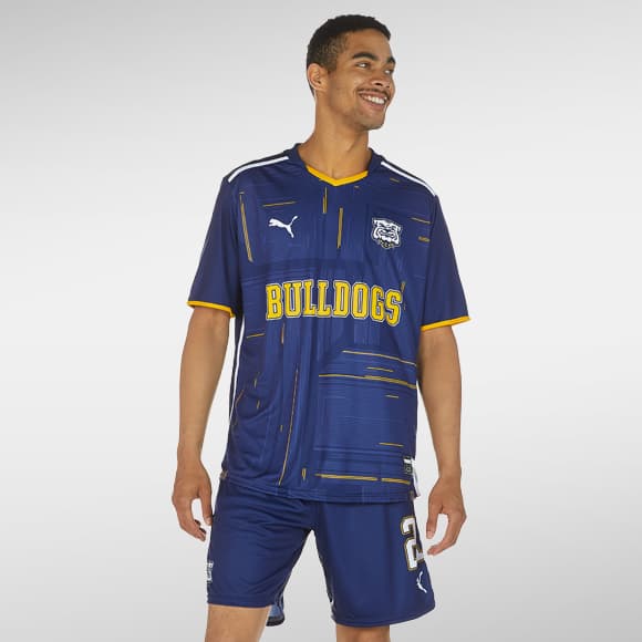 A male soccer player wearing a customized PUMA team uniform