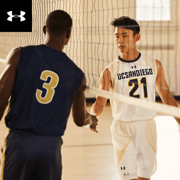 Two players shaking hands under a net wearing under armour uniforms